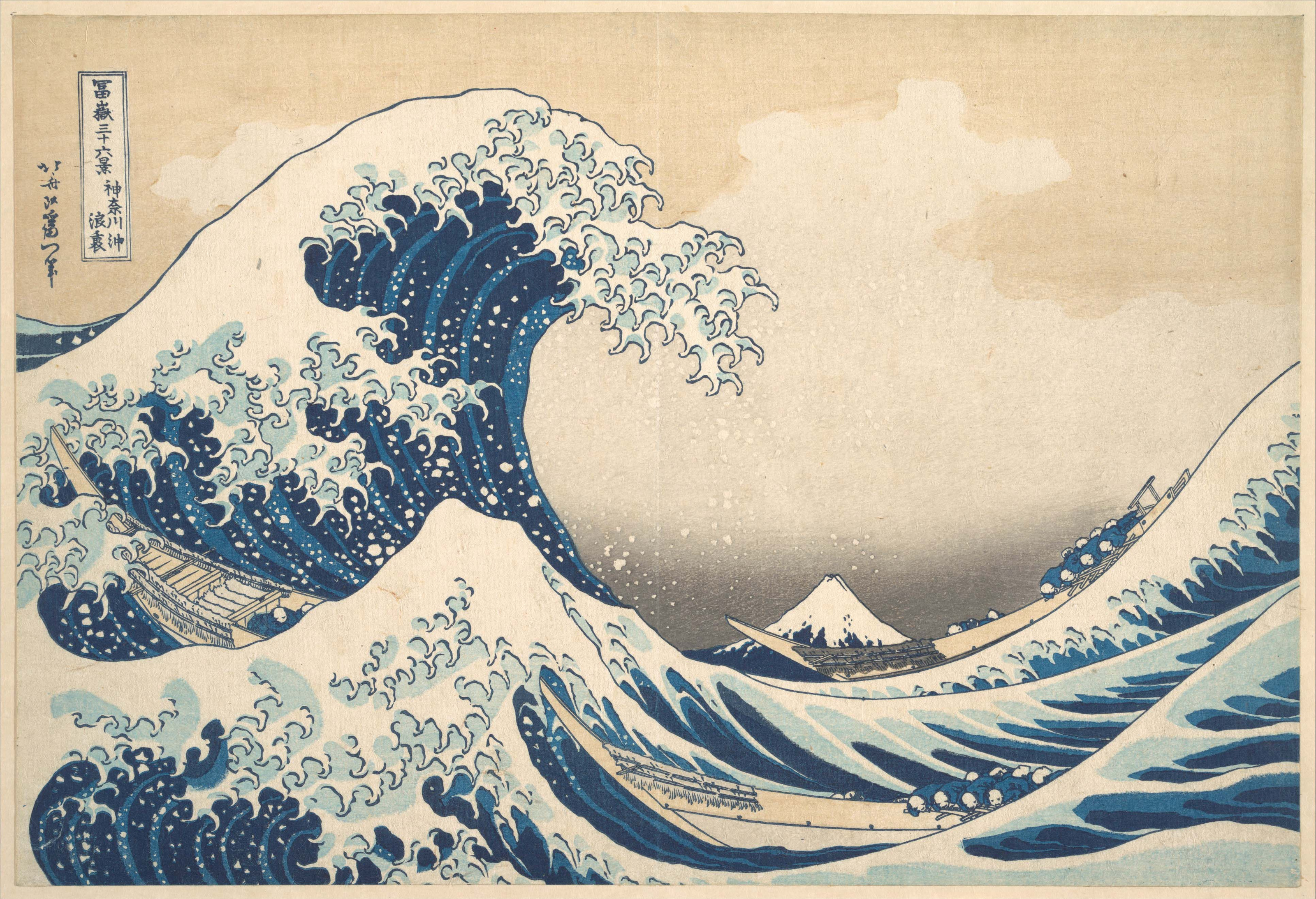Hokusai’s towering blue wave and white foam above wooden boats, with Mount Fuji in the distance